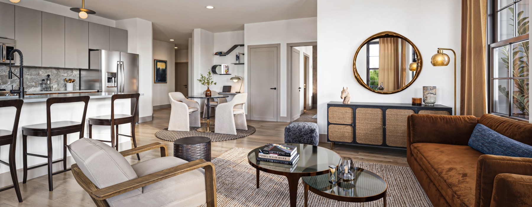 modern living room with couch, tables, and kitchen