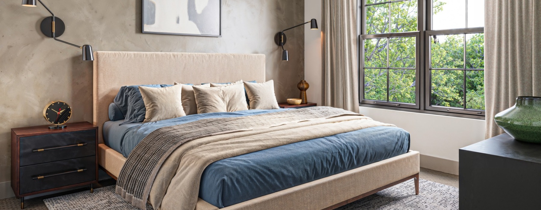 Bedroom with big window and blue bed sheets