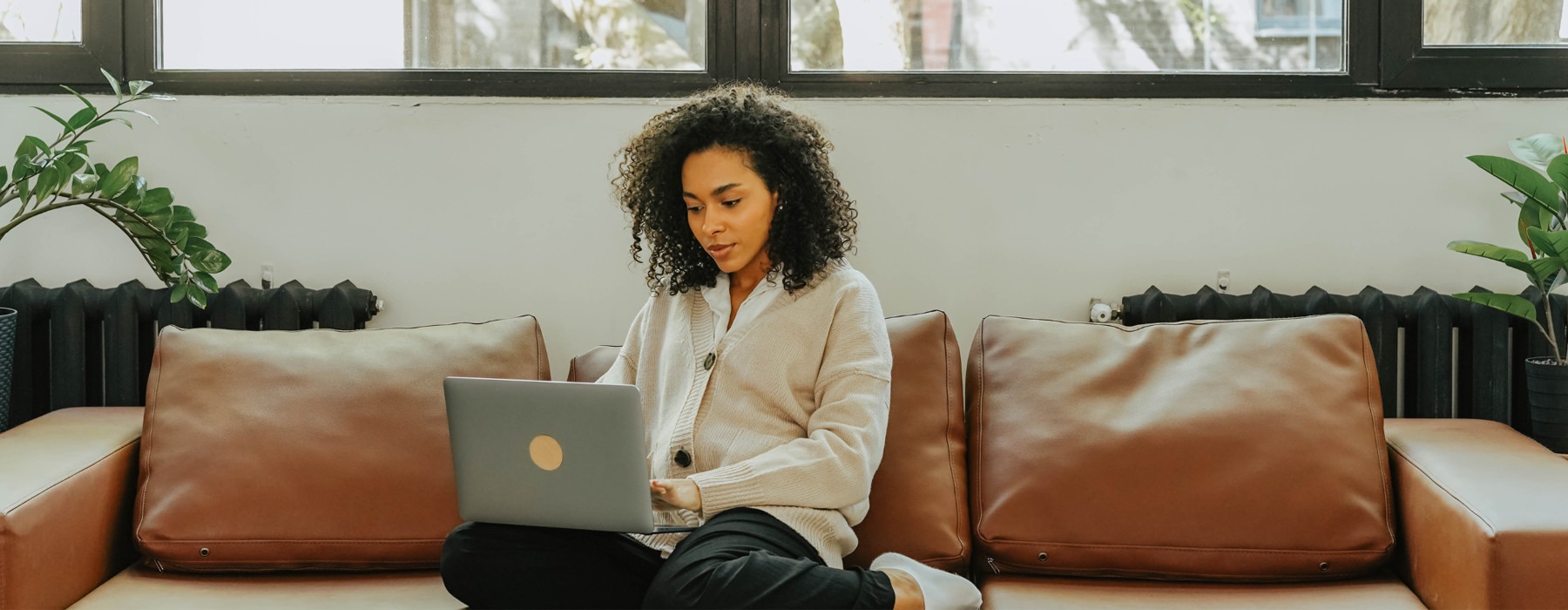 woman on laptop sitting on couch